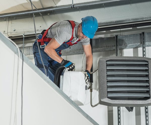 HVAC Technician Installing New Warehouse Air and Water Heaters