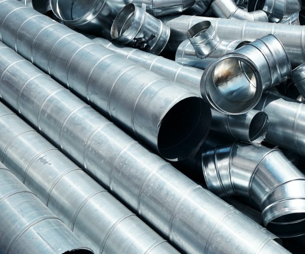 Pile of pipes and parts for duct systems. Industrial ventilation
