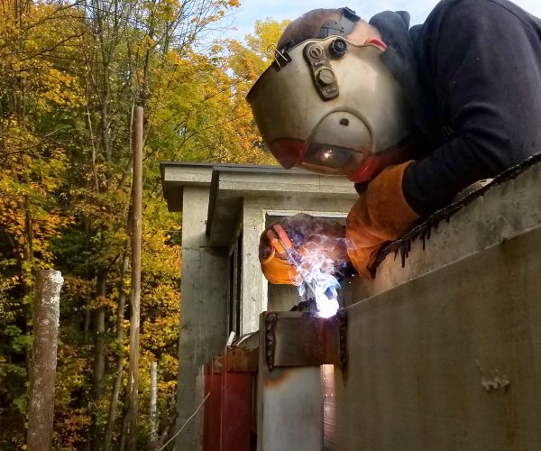 Worker welding in a factory. Welding on an industrial plant.