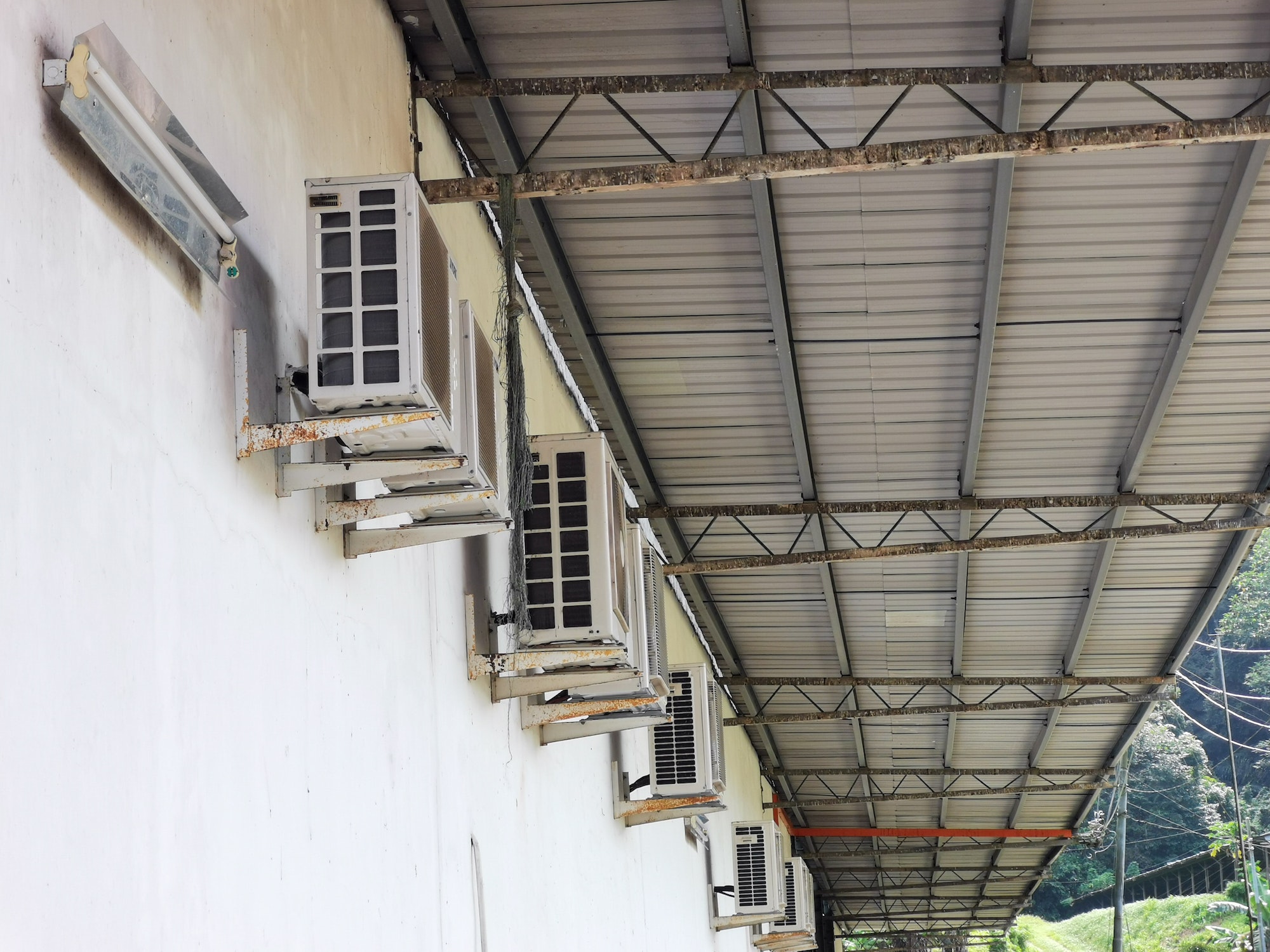 Image of a row of condenser unit on the wall. Selective focus.