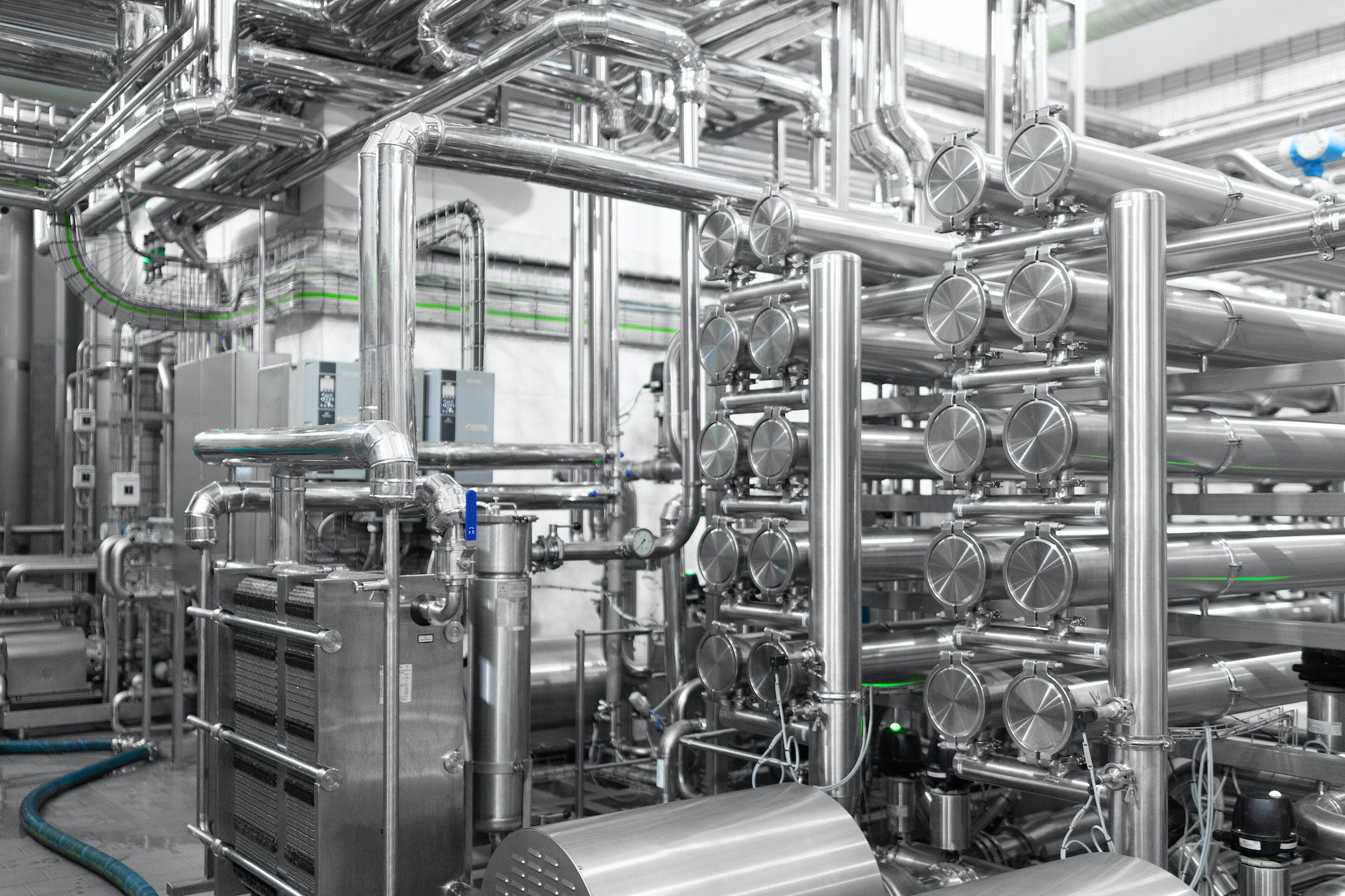 Steel water pipeline, chrome pipes, pipe lines in plant workshop. Industrial background